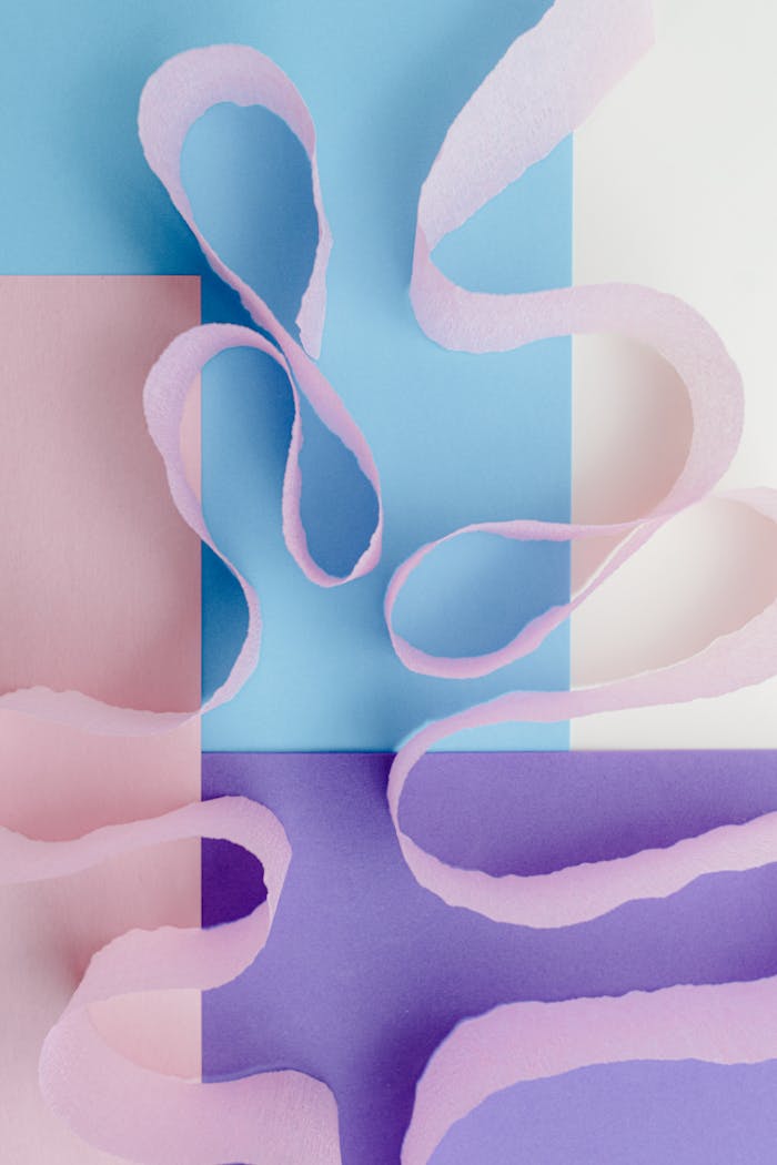 Artistic abstract of pastel ribbons and geometric shapes for creative design.